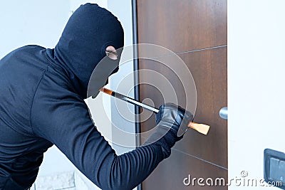 Burglar trying to force a door lock Stock Photo