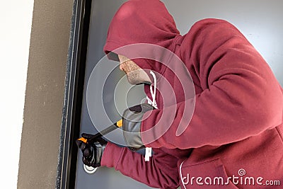 Burglar trying to force a door lock Stock Photo