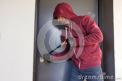 Burglar trying to force a door lock Stock Photo