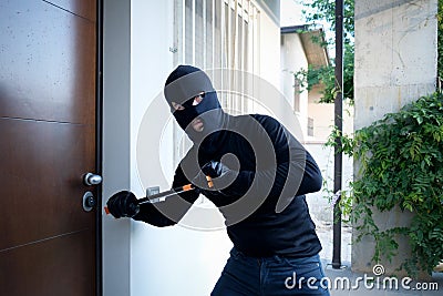 Burglar trying to force a door lock Stock Photo