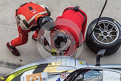 BURIRAM, THAILAND - JANUARY 7, 2017: Technicians changing tire Editorial Stock Photo