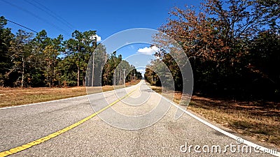 POV driving country low to the ground fall season long road Stock Photo