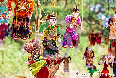 Burma colorful puppet in a tourist stall in the street. Souvenir items for sale in Myanmar. Hanging on display. Stock Photo