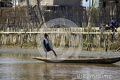 Burmese child poling a boat Editorial Stock Photo
