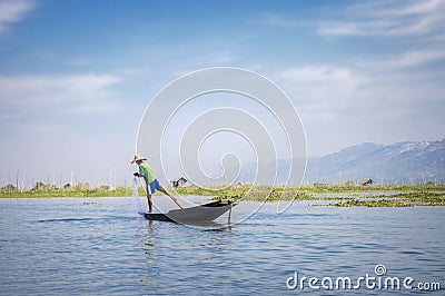 Burmese fisherman catching fish with a net on Inle lake, Myanmar Burma Editorial Stock Photo