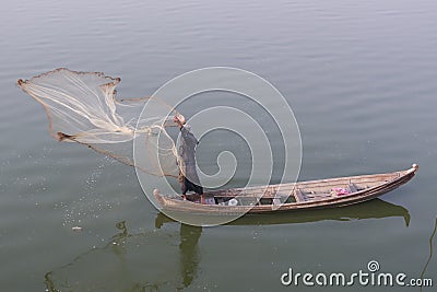 Burmese fisherman throwing a fishing net in Taungthaman lake, Burma Editorial Stock Photo