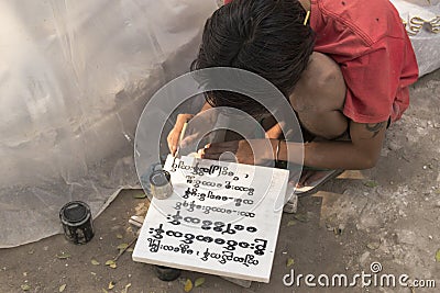 Burmese local writing old inscription on marble block, Mandalay, Burma Editorial Stock Photo