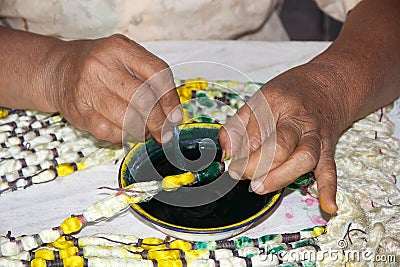 Burmese woman is colouring the lotus thread Stock Photo