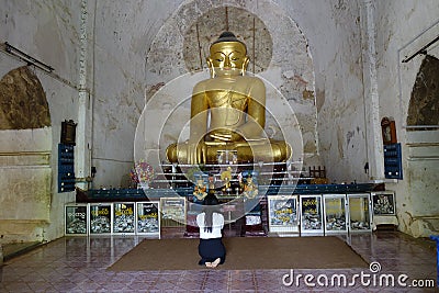 Burmese woman praying inside pagoda Editorial Stock Photo