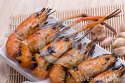 Burn shrim and Seafood sauce on wooden table. Stock Photo