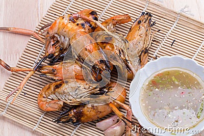 Burn shrim and Seafood sauce on wooden table. Stock Photo