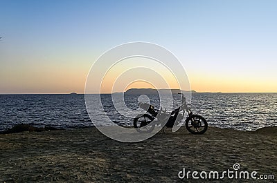 Burned abandoned motorcycle on the beach - Zakynthos / Zante island Stock Photo