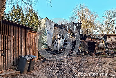 Burned barn, garage and car. Sunny spring day Stock Photo