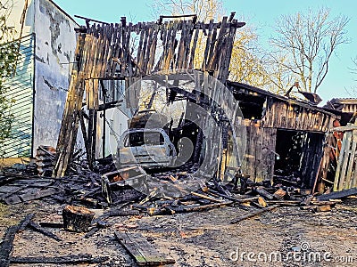 Burned barn, garage and car. Sunny spring day Stock Photo