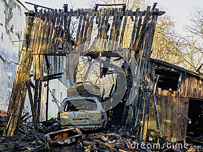 Burned barn, garage and car. Sunny spring day Stock Photo