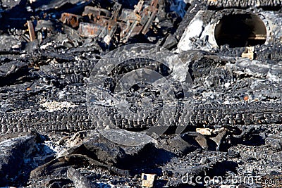 Burned debri on the ground from recent fire Stock Photo