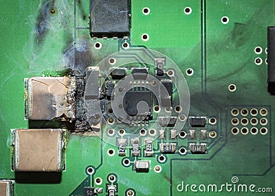 Burned electronic SMD printed circuit board PCB after a short circuit Stock Photo