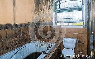 Burned house interior after fire, ruined building a toilet after fire inside Stock Photo