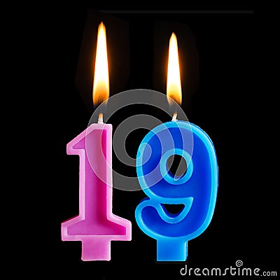 Burning birthday candles in the form of 19 nineteen figures for cake isolated on black background. Stock Photo