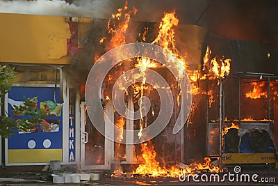 Burning building in the city. Fire extinguishing operation Editorial Stock Photo