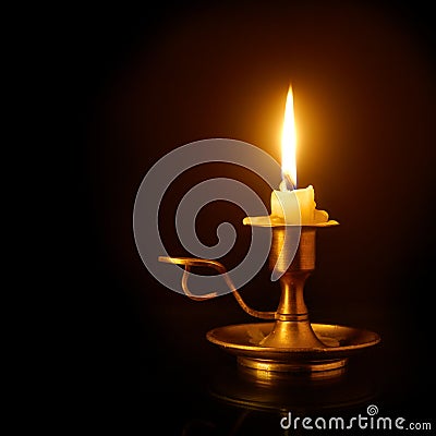 Burning candle on candlestick Stock Photo