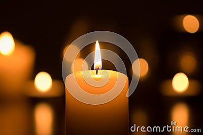 Burning candle in dark Stock Photo