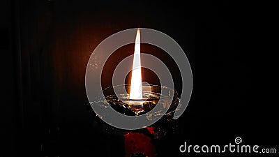 Burning candle in the darkness Stock Photo