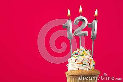 Burning candle number 121 - Birthday card with cupcake Stock Photo