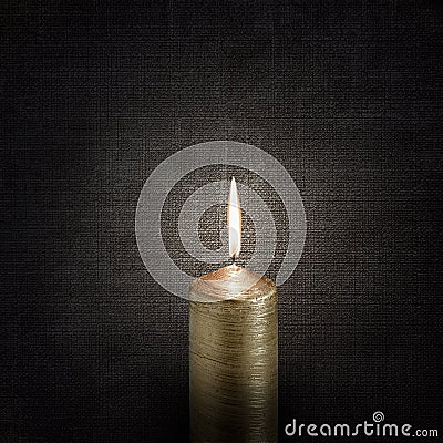 Burning candle over vintage embossed dark backgrounds Stock Photo