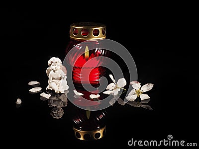 Burning candle in a red glass candlestick Stock Photo