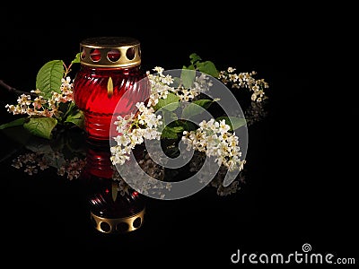 Burning candle in a red glass candlestick Stock Photo