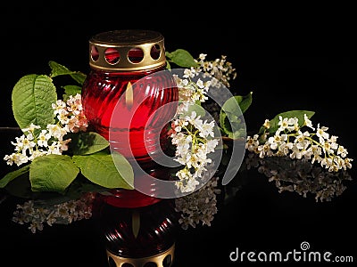 Burning candle in a red glass candlestick Stock Photo