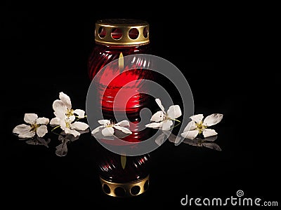 Burning candle in a red glass candlestick Stock Photo