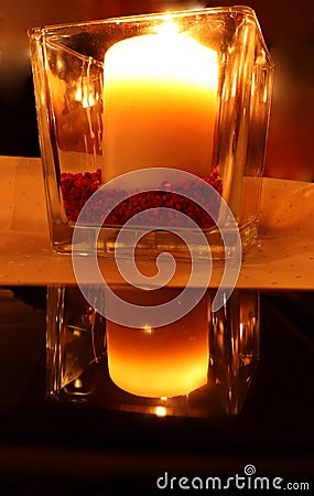 Burning candle with a reflection Stock Photo