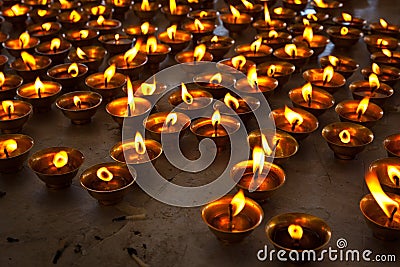 Burning candles in Buddhist temple Stock Photo