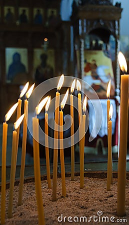 Burning candles in a church Stock Photo