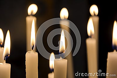 a group of burning candles in a church Stock Photo