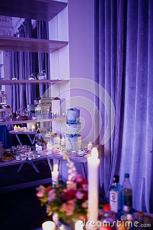 Burning candles on a festive table. A festive table with candles Stock Photo