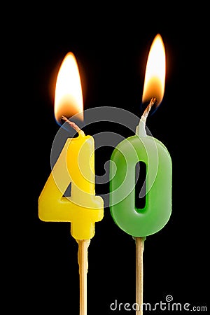 Burning candles in the form of forty figures numbers, dates for cake on black background. The concept of celebrating a Stock Photo