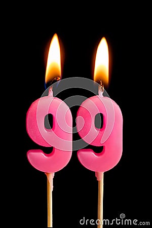 Burning candles in the form of 99 ninety nine numbers, dates for cake isolated on black background. The concept of celebrating a Stock Photo