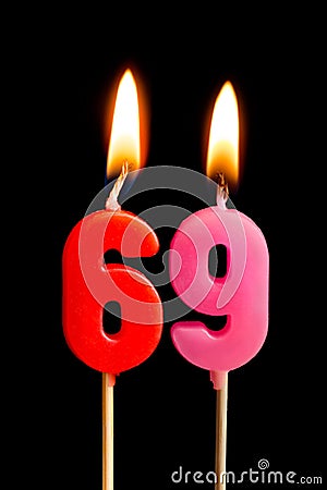 Burning candles in the form of 69 sixty nine numbers, dates for cake isolated on black background. The concept of celebrating a Stock Photo