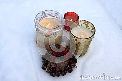 Burning candles in glass candlesticks and Christmas bells Stock Photo