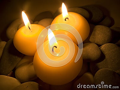 Burning Candles on Sea Stones Stock Photo