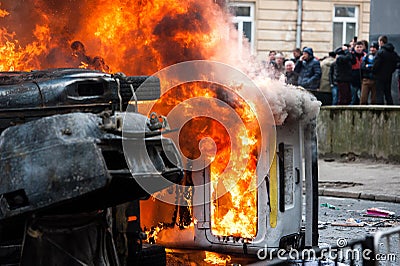 Burning car. car destroyed and set on fire during the riots. city center Editorial Stock Photo