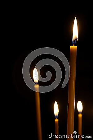 Burning in the dark taper candles Stock Photo