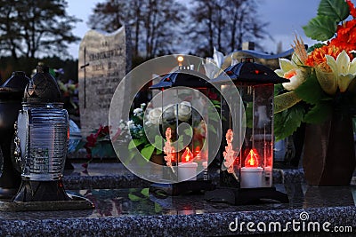 Burning electric candles in the evening at the cemetery. All Saints Stock Photo