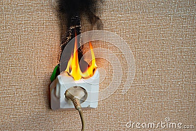 Burning electrical wiring and electrical outlet. Faulty wiring causes fires. Poor old wiring causes a fire in the electrical Stock Photo