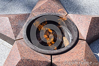 Burning of eternal fire. Five-pointed star made of granite memorial to the memory of killed soldiers Editorial Stock Photo