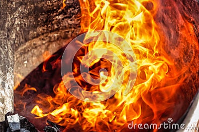 Burning fire close up. Bright orange and red flames on a dark background. Open flame heating. Problems with heating and gas Stock Photo