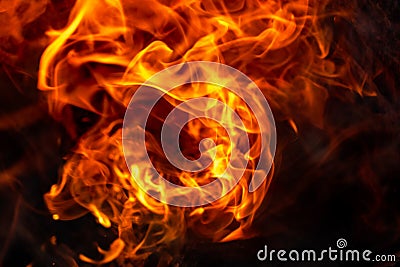 Burning fire close up. Bright orange and red flames on a dark background. Open flame heating. Problems with heating and gas Stock Photo